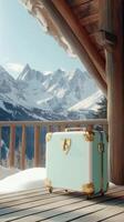Beautiful winter landscape with a vintage suitcase on a wooden deck in mountains photo
