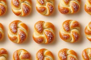 Freshly baked sweet rolls arranged in a neat pattern on a light background photo