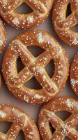 Freshly baked pretzels with colorful sprinkles arranged neatly in a pattern photo