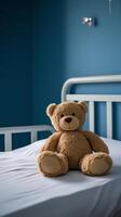 Soft bear sitting on a bed in a cozy blue room with calming atmosphere photo