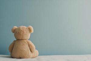Soft bear gazing out a bright window in a serene bedroom setting photo