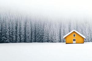 Bright yellow house in a snowy landscape during winter with trees in the background photo