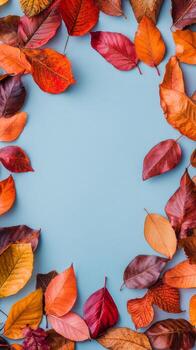 Colorful autumn leaves arranged on a blue background creating a seasonal display photo