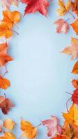 Colorful autumn leaves arranged on a blue background creating a seasonal display photo