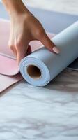 Hand unrolling pastel colored craft paper on a wooden surface during a creative project photo