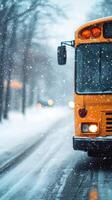Bright yellow bus parked on a snowy road surrounded by tall trees in winter photo