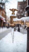Winter scene features frozen faucet with icicles in urban neighborhood photo