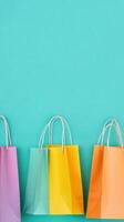 Colorful shopping bags arranged on a green backdrop for a vibrant retail display photo