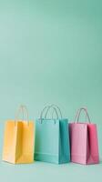 Colorful shopping bags arranged on a green backdrop for a vibrant retail display photo