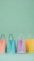Colorful shopping bags arranged on a green backdrop for a vibrant retail display photo