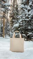 Winter scene featuring a light bag resting in a snowy forest surrounded by evergreen trees photo