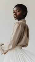 Elegant model showcases fashion with neutral tones in studio setting photo