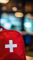 First aid kit placed on a table in a bright room with soft lighting and blurred background photo