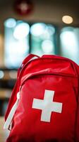 First aid kit placed on a table in a bright room with soft lighting and blurred background photo