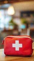 First aid kit placed on a table in a bright room with soft lighting and blurred background photo