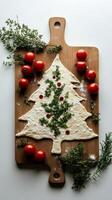 Festive dough shaped like a Christmas tree with tomatoes and herbs for holiday baking photo