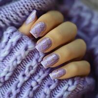 Elegant lavender nail design with gold accents on a cozy winter sweater background photo