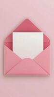 Soft pink envelope with blank card surrounded by decorative pink petals on a pastel surface photo