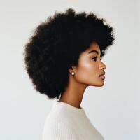 Profile of a young woman with natural curls, captured in soft light, showcasing elegance and beauty photo