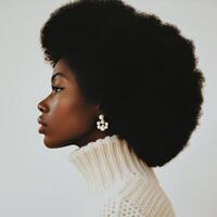 Model showcases natural hairstyle in profile against simple background during a studio shoot photo