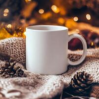 Cozy white mug resting on knitted blanket surrounded by pine cones and warm lights photo