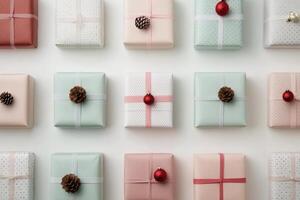 Beautifully wrapped holiday gifts arranged neatly on a white surface with pine cones photo