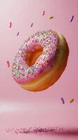 Delicious donut with sprinkles flying above colorful candy decorations photo