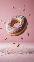 Delicious donut with sprinkles flying above colorful candy decorations photo