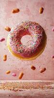 Delicious donut with sprinkles flying above colorful candy decorations photo