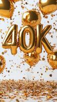 Golden 40K balloons with colorful confetti on a white background for the celebration photo