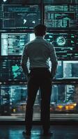 Professional analyzing data on multiple screens in modern office at night photo
