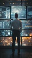 Professional analyzing data on multiple screens in modern office at night photo