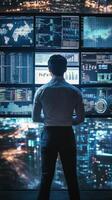 Professional analyzing data on multiple screens in modern office at night photo