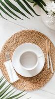 Elegant breakfast table setting with white dishware and natural elements photo