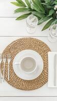 Elegant breakfast table setting with white dishware and natural elements photo