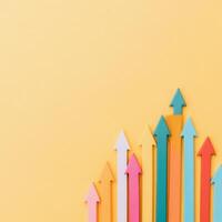Colorful arrows pointing upwards on a yellow background symbolize growth and progress photo