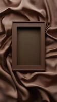 Unique wooden frame on a backdrop of flowing brown fabric in an artistic setting photo