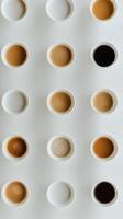 Different shades of coffee served in cups arranged on a white background in a cafe photo