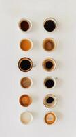 Different shades of coffee served in cups arranged on a white background in a cafe photo
