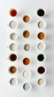 Different shades of coffee served in cups arranged on a white background in a cafe photo