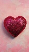 Shiny red heart shaped decoration on soft pink background for festive occasions photo