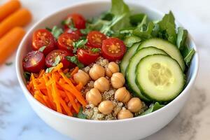 Healthy quinoa salad with cucumbers, tomatoes, and chickpeas served in a bowl photo