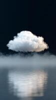 Cloud hovering above calm water with mist in serene atmosphere photo