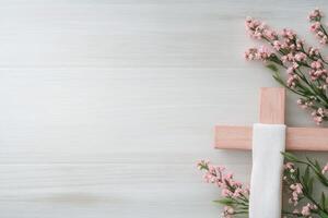 Religious symbol of faith surrounded by delicate flowers on a light wooden background photo