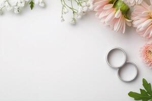 Elegant wedding rings surrounded by delicate flowers on fresh background photo