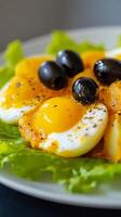 Delicious layered dish topped with olives served on fresh lettuce photo