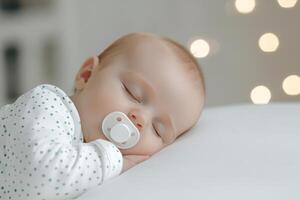 Adorable sleeping baby with pacifier surrounded by soft warm lights in cozy setting photo