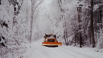 Snowplow clearing a winter road under a cloudy sky during snowfall photo