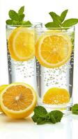 Refreshing lemon and mint beverage served in tall glasses with bubbles and garnishes photo