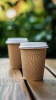 Coffee cup on wooden table surrounded by greenery in a cozy cafe setting during the afternoon photo